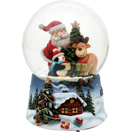 Снігова куля-Санта з оленем і пінгвіном - на синьому постаменті з різдвяним зимовим пейзажем і іграшковими іграшками.