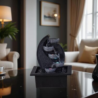 Джерело води Zen'Light Zimmerbrunnen V2 з 4 рівнями, імітація натурального каменю та кольоровим LED-підсвічуванням. Сучасна декор для столу, ідеально для медитації та релаксації. Висота 26 см. Унікальний дизайн.