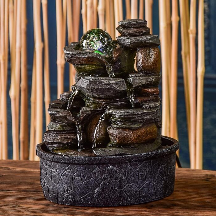 Джерело води Zen'Light від Zimmerbrunnen: природний водоспад з ефектом каменів та кольоровим LED-підсвічуванням. Ідеальна декор для дому, медитації та релаксації. Об'єкт Фен-Шуй для щастя. Висота 23 см (Satya)